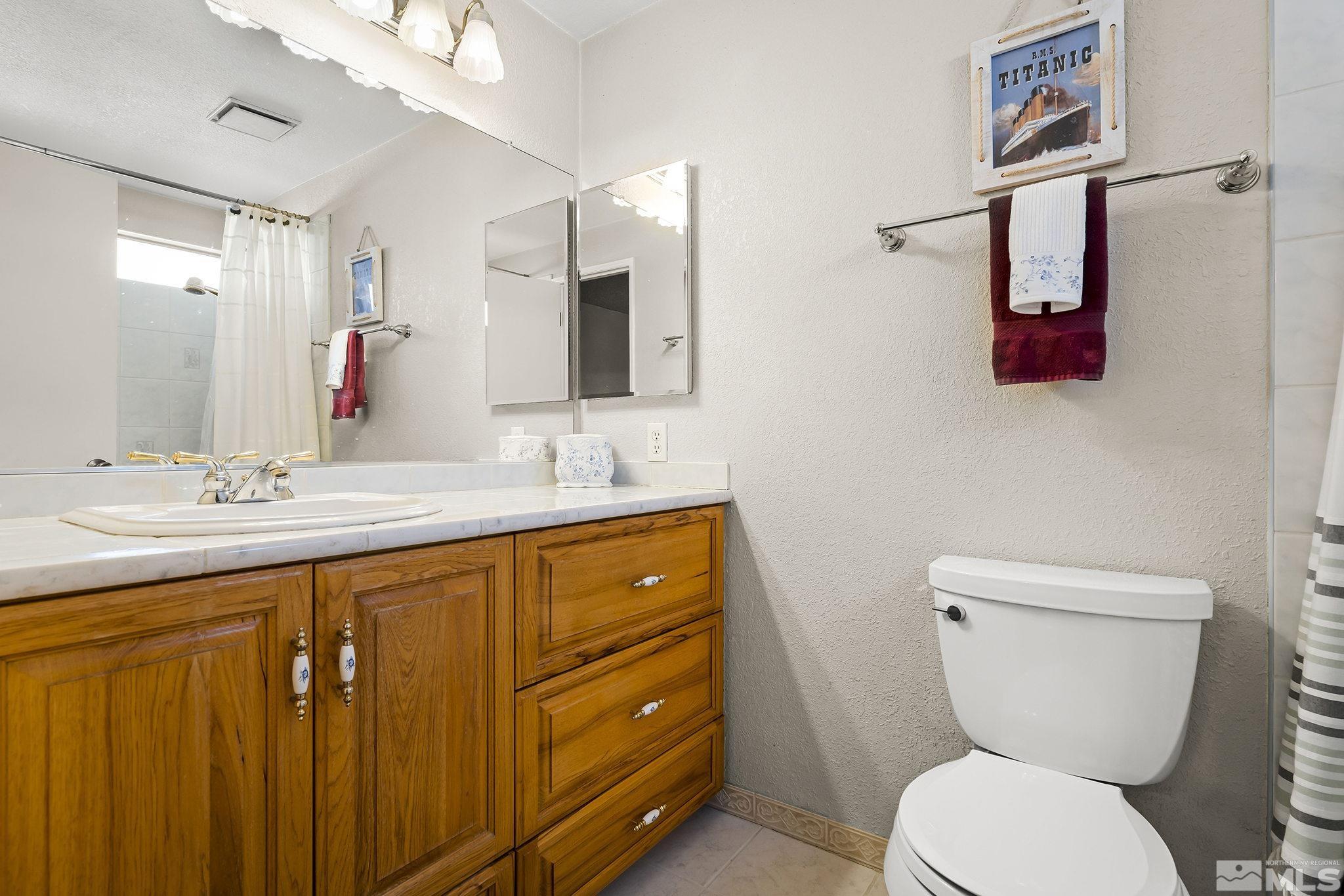 1608 Del Rosa Way Sparks, NV 89434 - Photo 13 of 18 a bathroom with a toilet sink and mirror