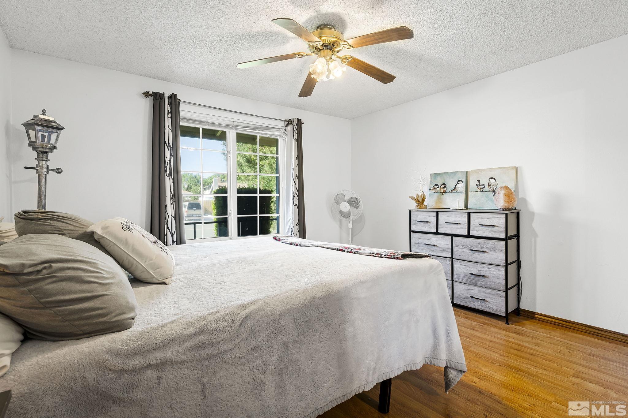1608 Del Rosa Way Sparks, NV 89434 - Photo 14 of 18 a bedroom with a bed and a window