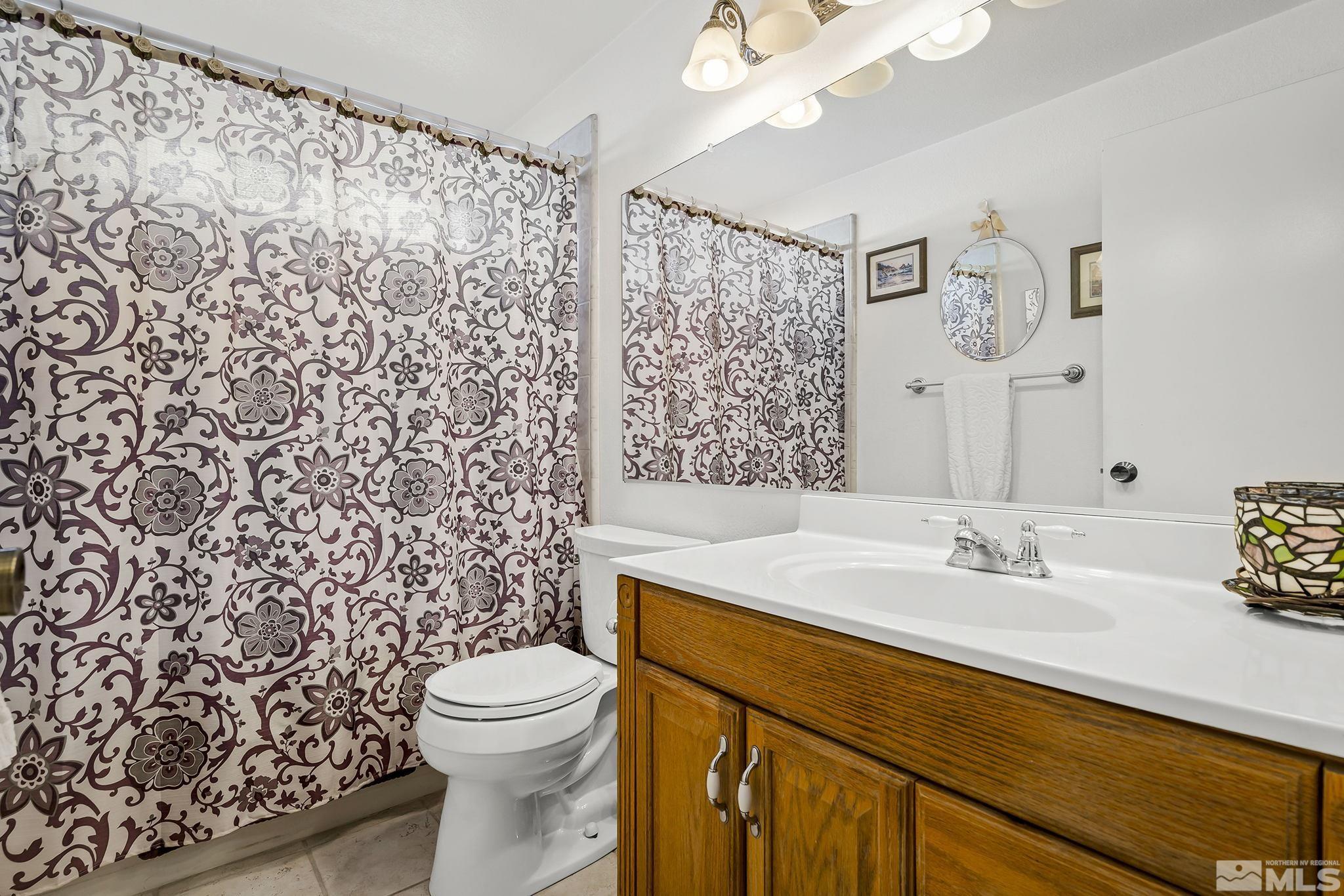 1608 Del Rosa Way Sparks, NV 89434 - Photo 15 of 18 a bathroom with a sink toilet and shower