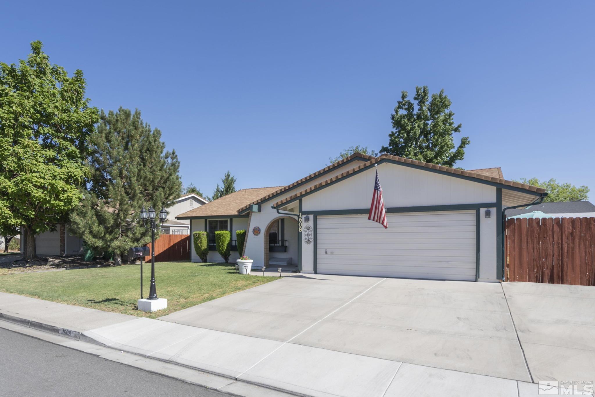 1608 Del Rosa Way Sparks, NV 89434 - Photo 3 of 18 a front view of a house with a yard