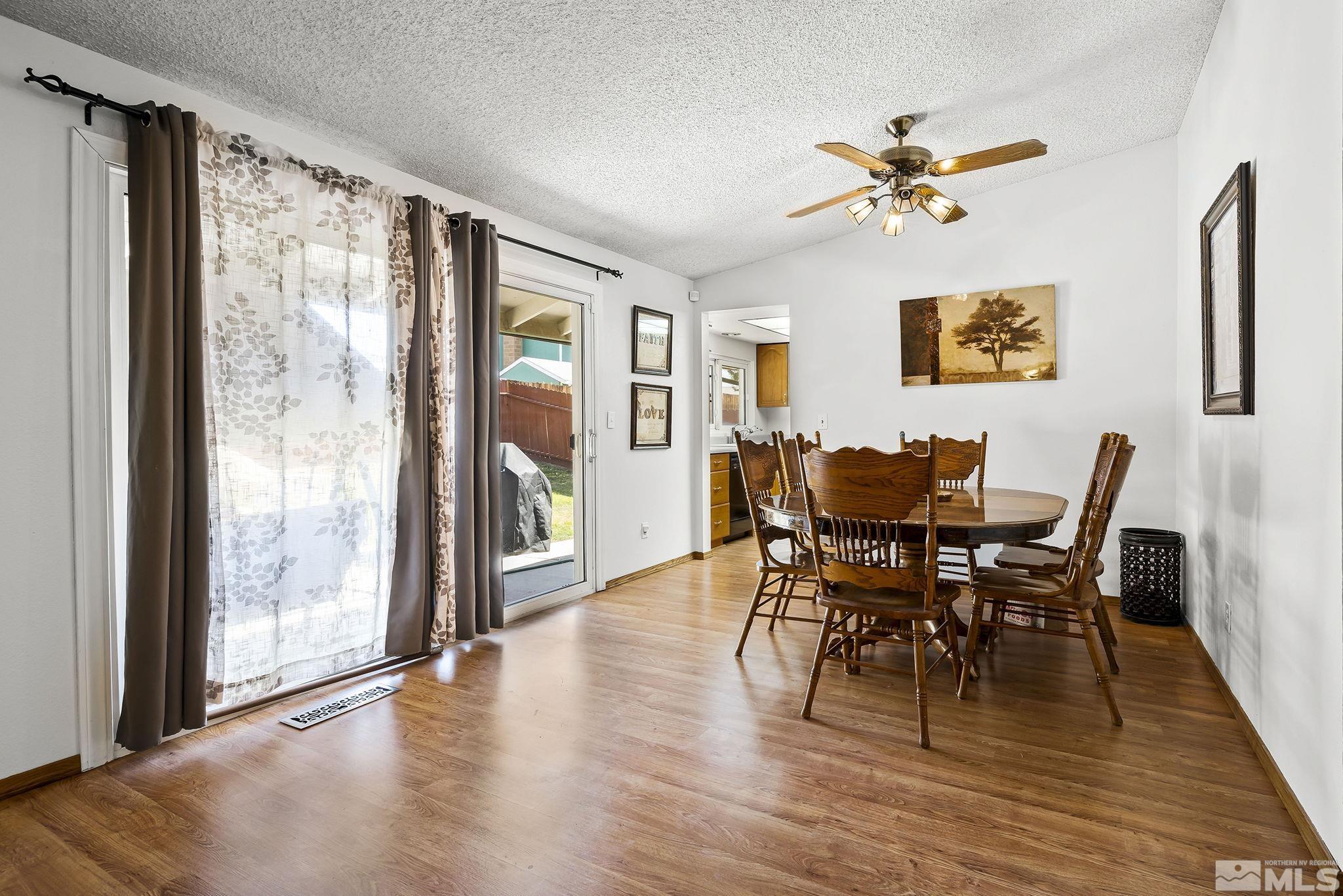 1608 Del Rosa Way Sparks, NV 89434 - Photo 7 of 18 a view of a dining room with furniture window and wooden floor