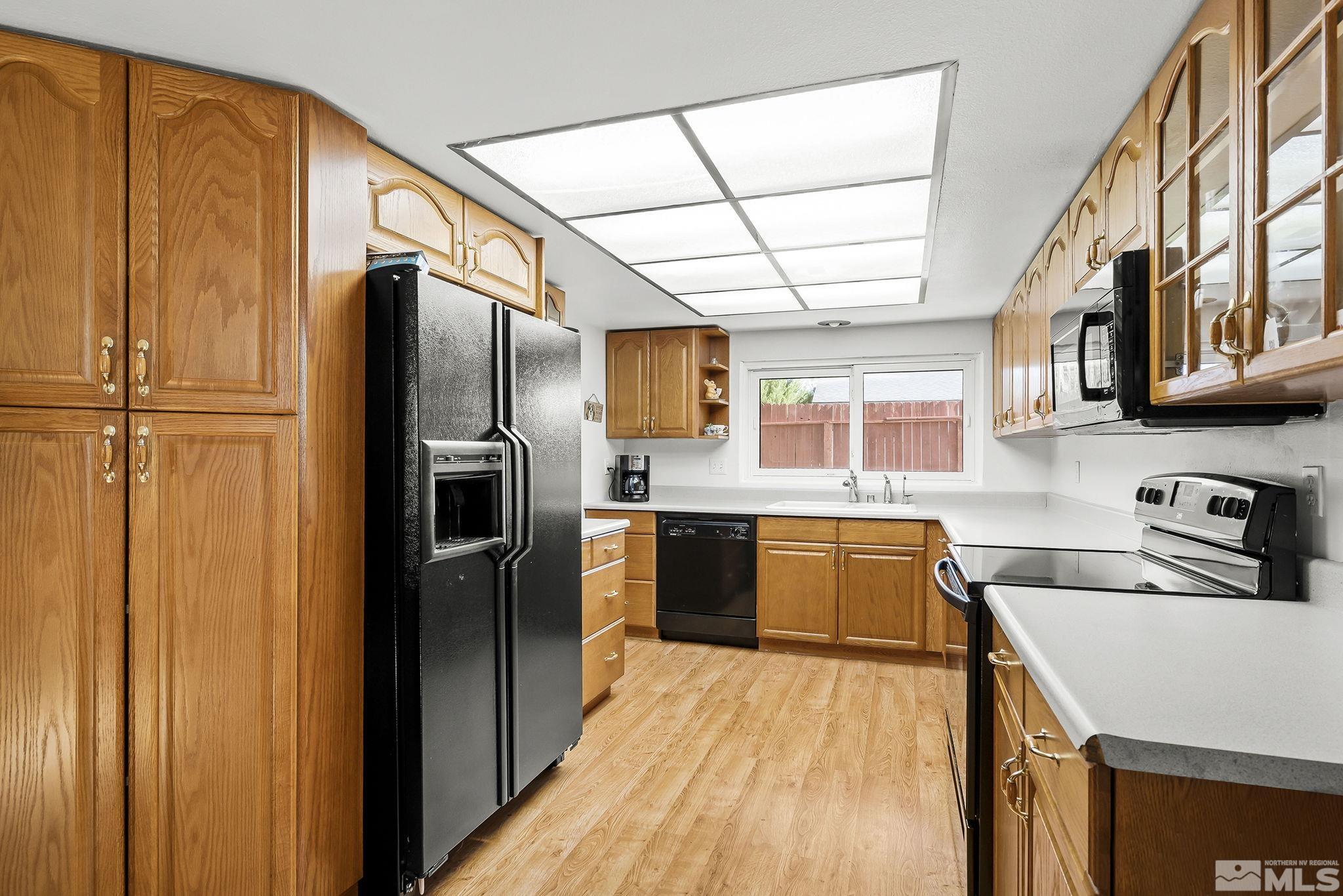 1608 Del Rosa Way Sparks, NV 89434 - Photo 8 of 18 a kitchen with stainless steel appliances granite countertop a refrigerator and a sink