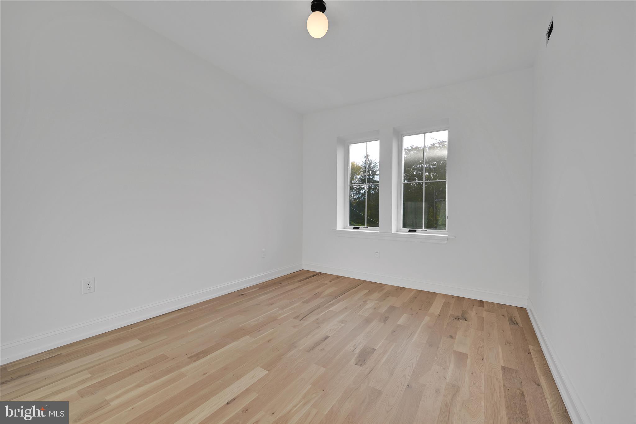 64 East Spring Avenue Ardmore, PA 19003 - Photo 14 of 26 wooden floor in an empty room with a window