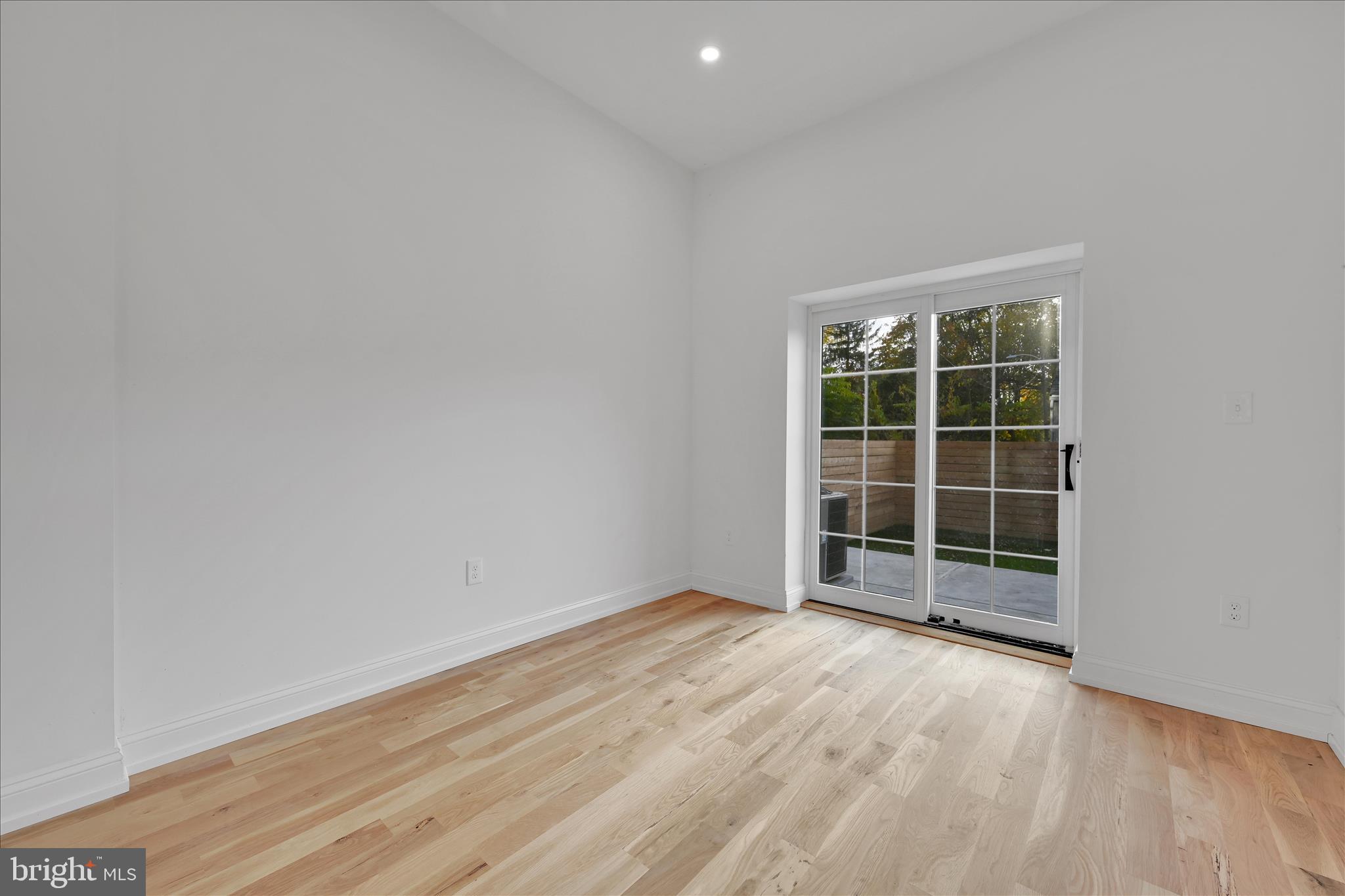 64 East Spring Avenue Ardmore, PA 19003 - Photo 6 of 26 an empty room with wooden floor and windows