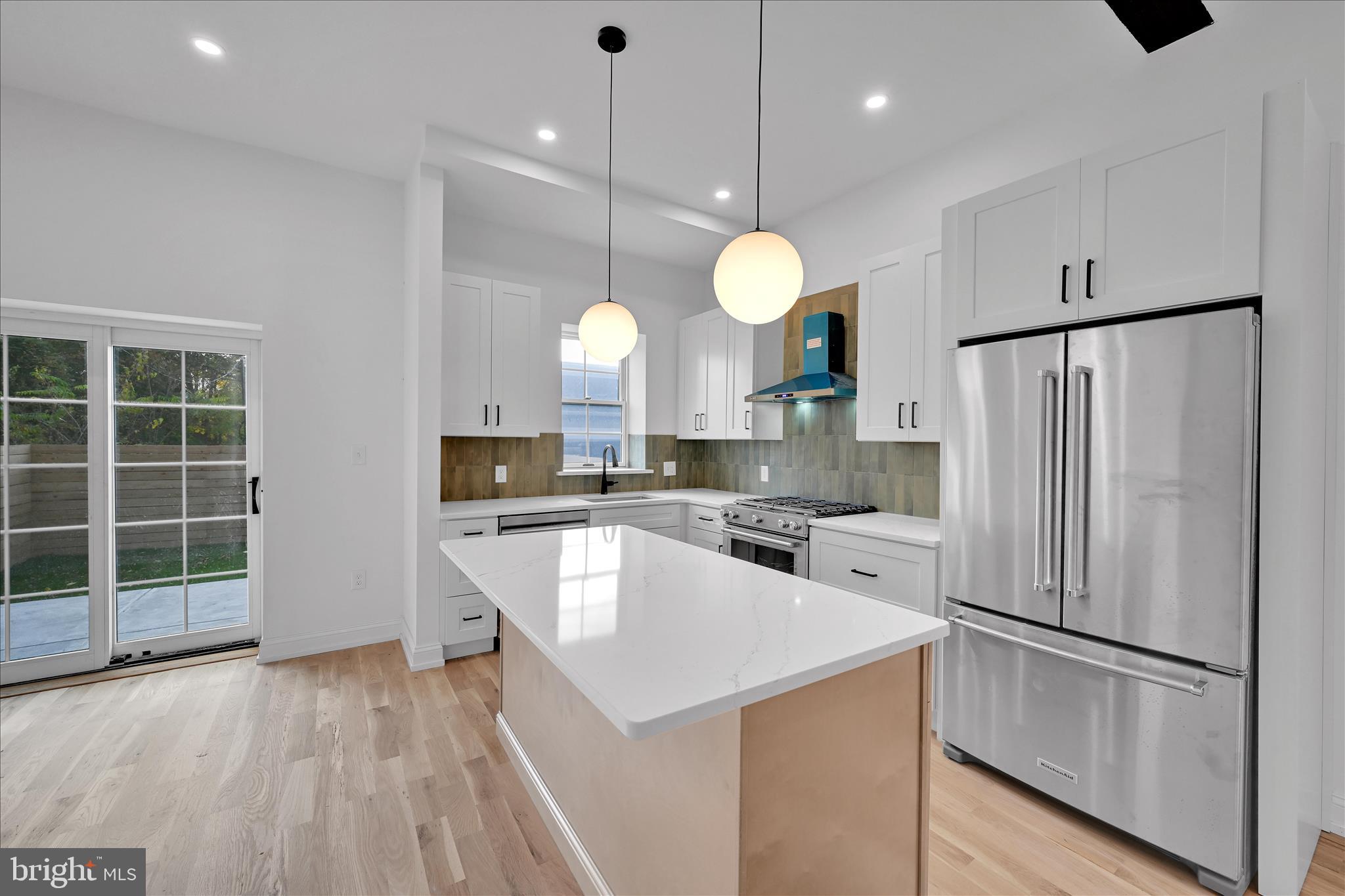 64 East Spring Avenue Ardmore, PA 19003 - Photo 7 of 26 a kitchen with white cabinets and stainless steel appliances