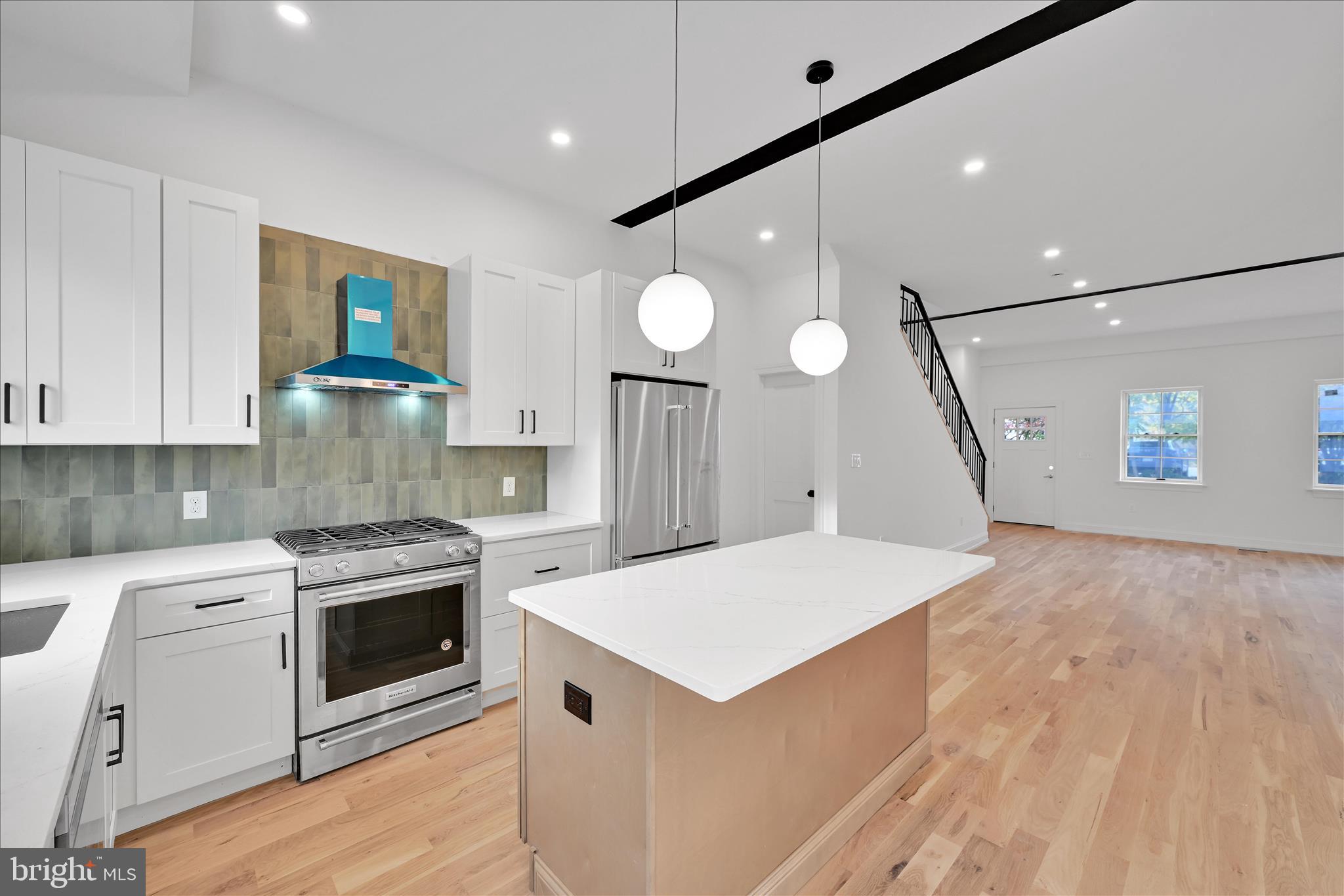 64 East Spring Avenue Ardmore, PA 19003 - Photo 10 of 26 a kitchen with a stove a sink and a refrigerator