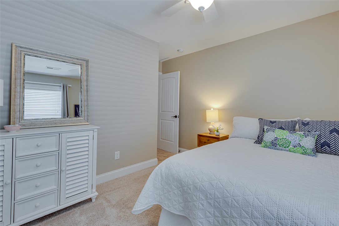203 Streams Way Anderson, SC 29625 - Photo 36 of 47 This inviting bedroom features soft carpeting, a bright ceiling fan, and ample space for rest and relaxation.