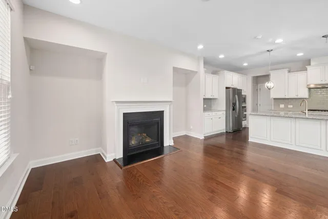 a view of a kitchen with a sink a refrigerator and a fireplace