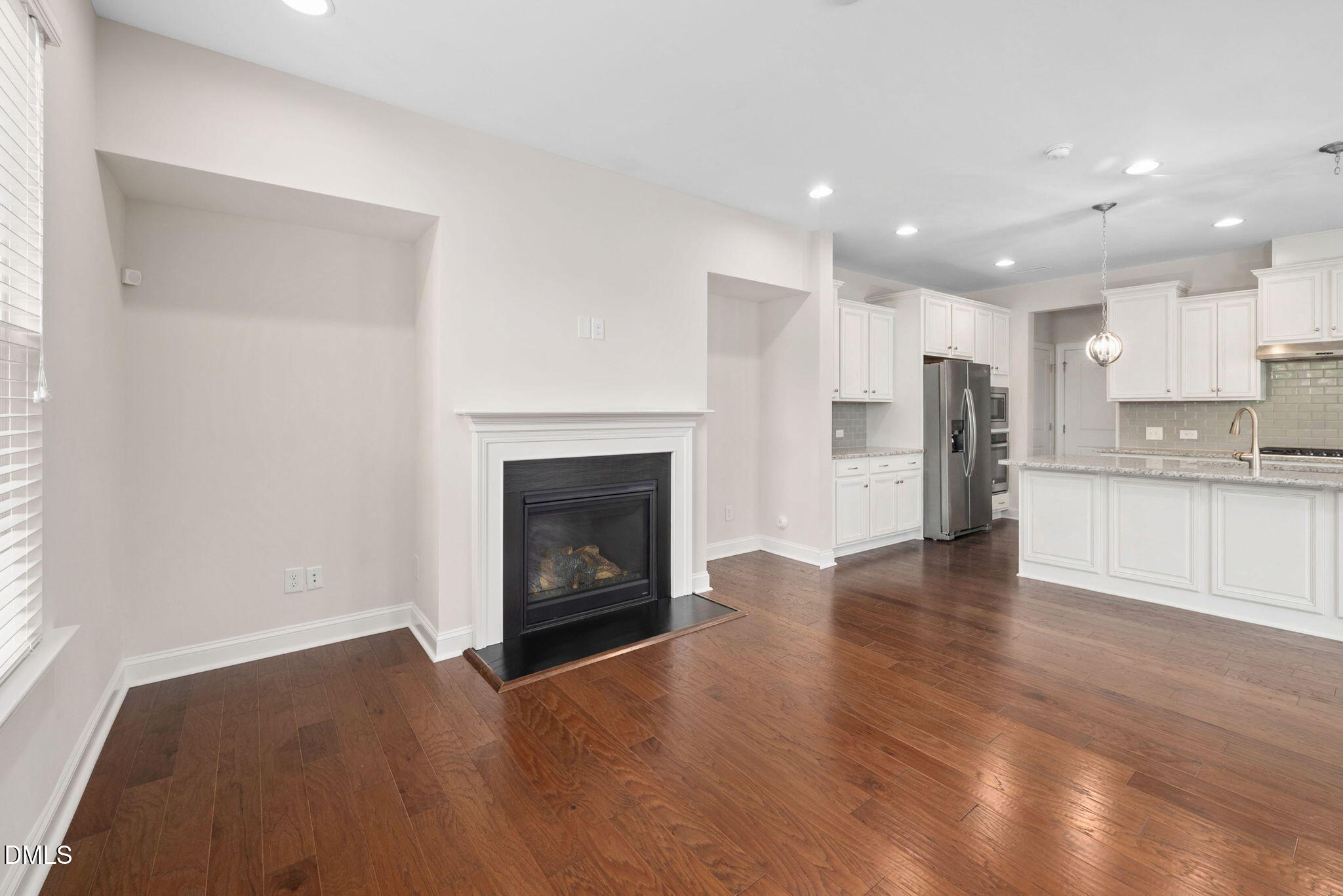 1103 Laurel Twist Road Cary, NC 27513 - Photo 11 of 38 a view of a kitchen with a sink a refrigerator and a fireplace
