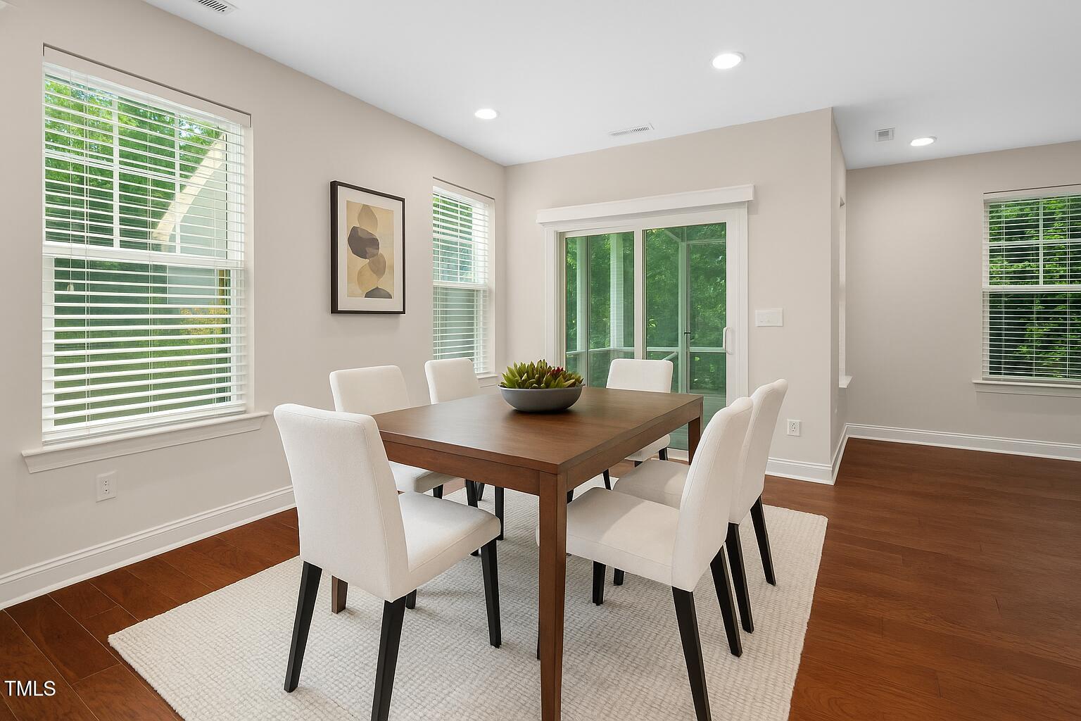 1103 Laurel Twist Road Cary, NC 27513 - Photo 14 of 38 a view of a dining room with furniture window and wooden floor