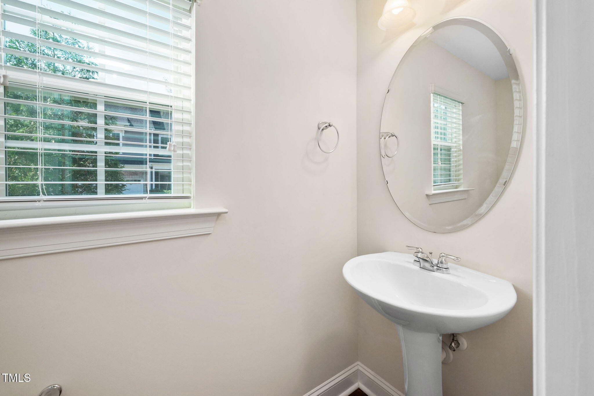 1103 Laurel Twist Road Cary, NC 27513 - Photo 15 of 38 a bathroom with a sink a mirror and a window