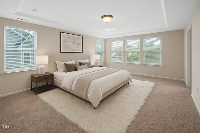 a bedroom with a bed and a large window