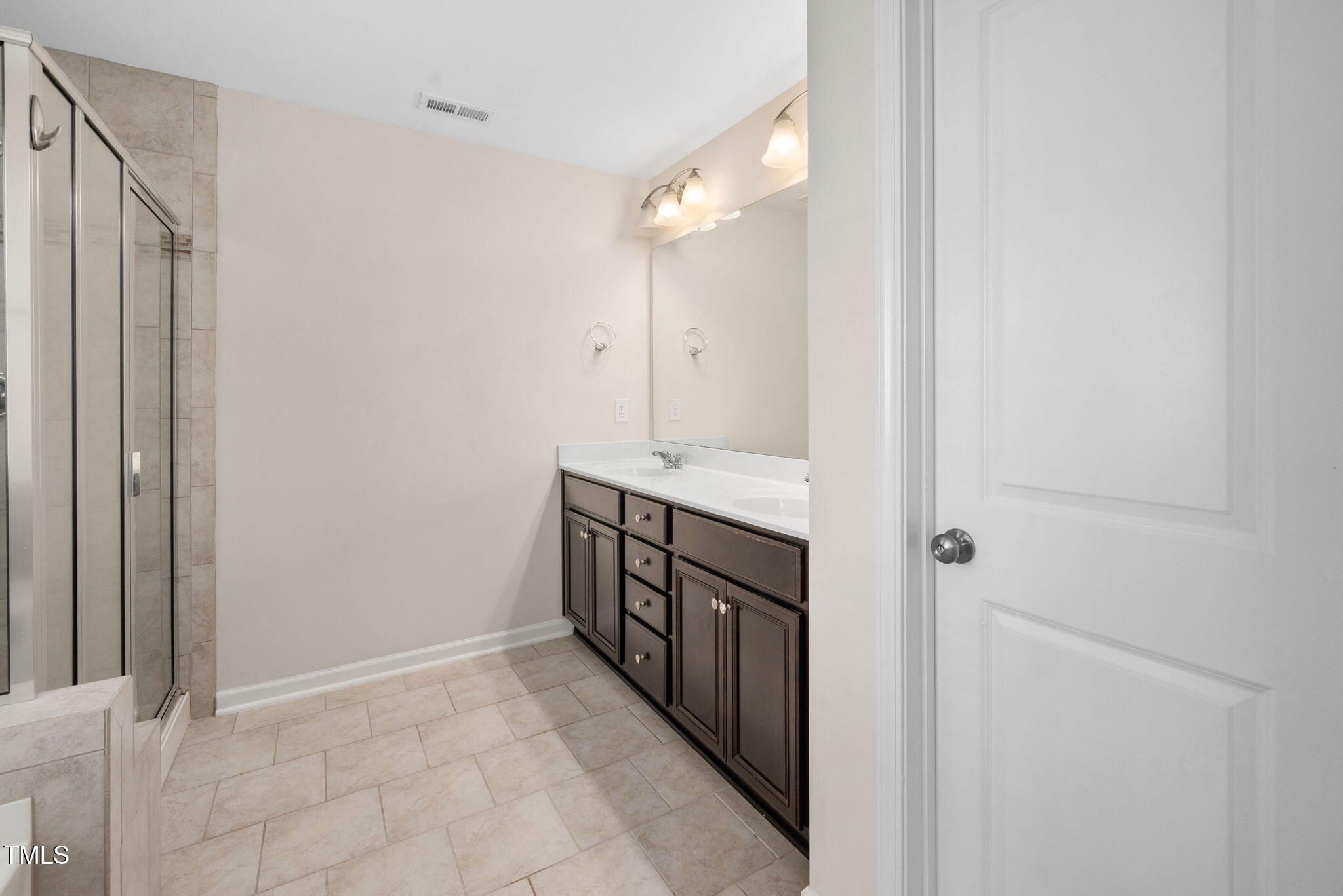 1103 Laurel Twist Road Cary, NC 27513 - Photo 20 of 38 a bathroom with a double vanity sink and a mirror