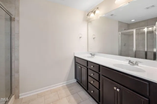 a bathroom with a double vanity sink and a mirror