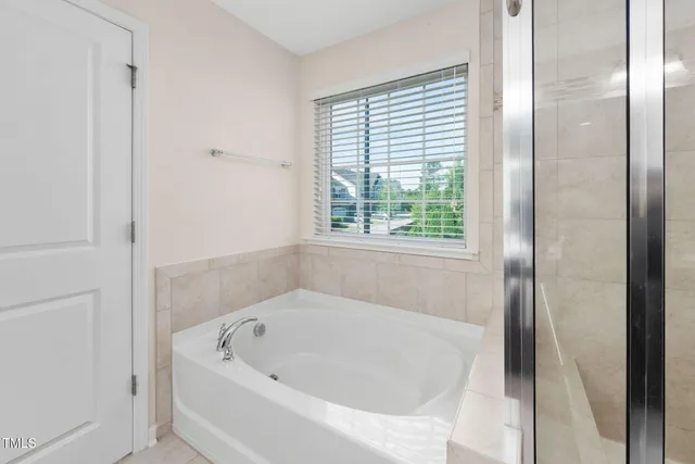 a white bath tub sitting next to a window