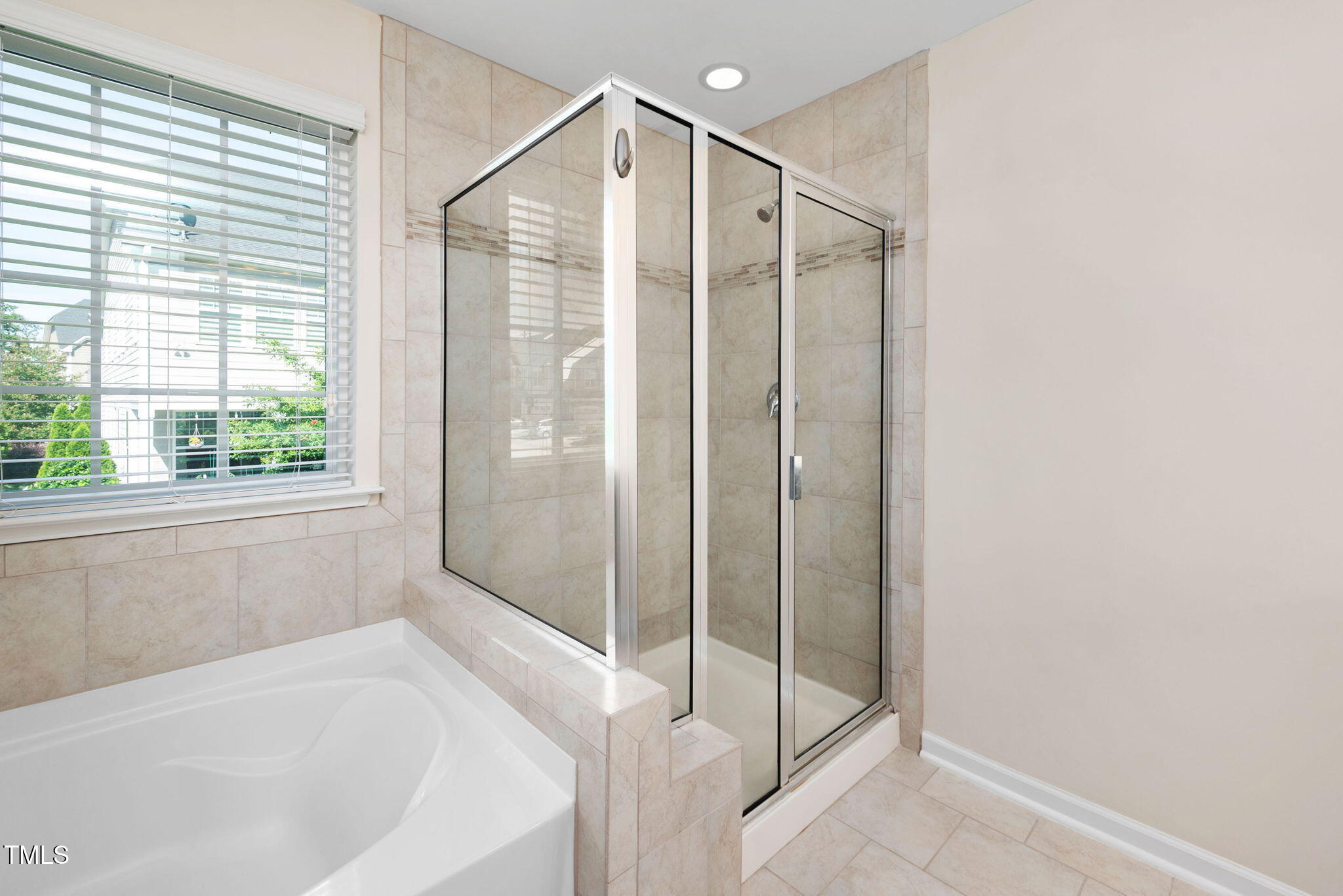1103 Laurel Twist Road Cary, NC 27513 - Photo 23 of 38 a bathroom with a bathtub and a shower