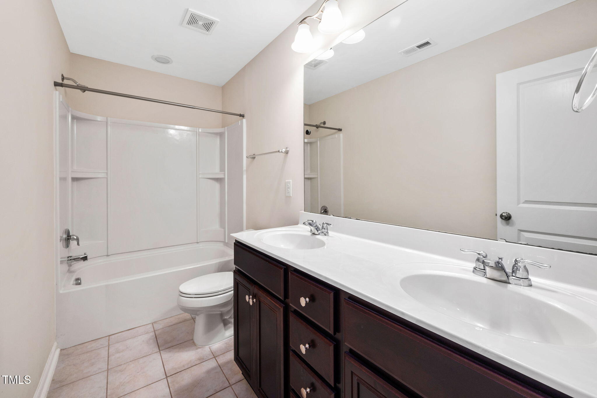 1103 Laurel Twist Road Cary, NC 27513 - Photo 26 of 38 a bathroom with a double vanity sink toilet mirror and shower