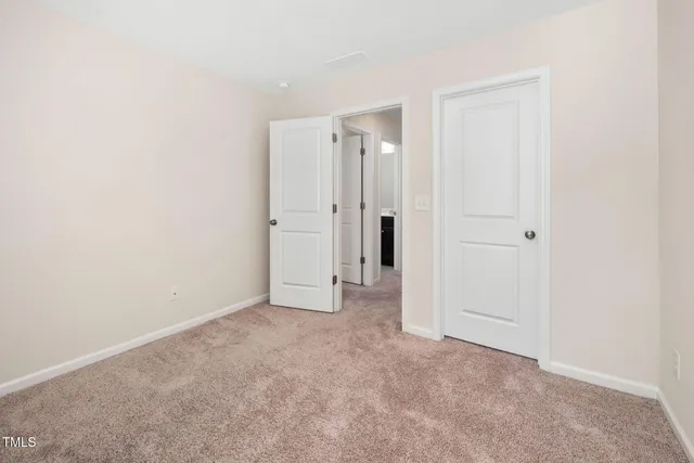 an empty room with closet area