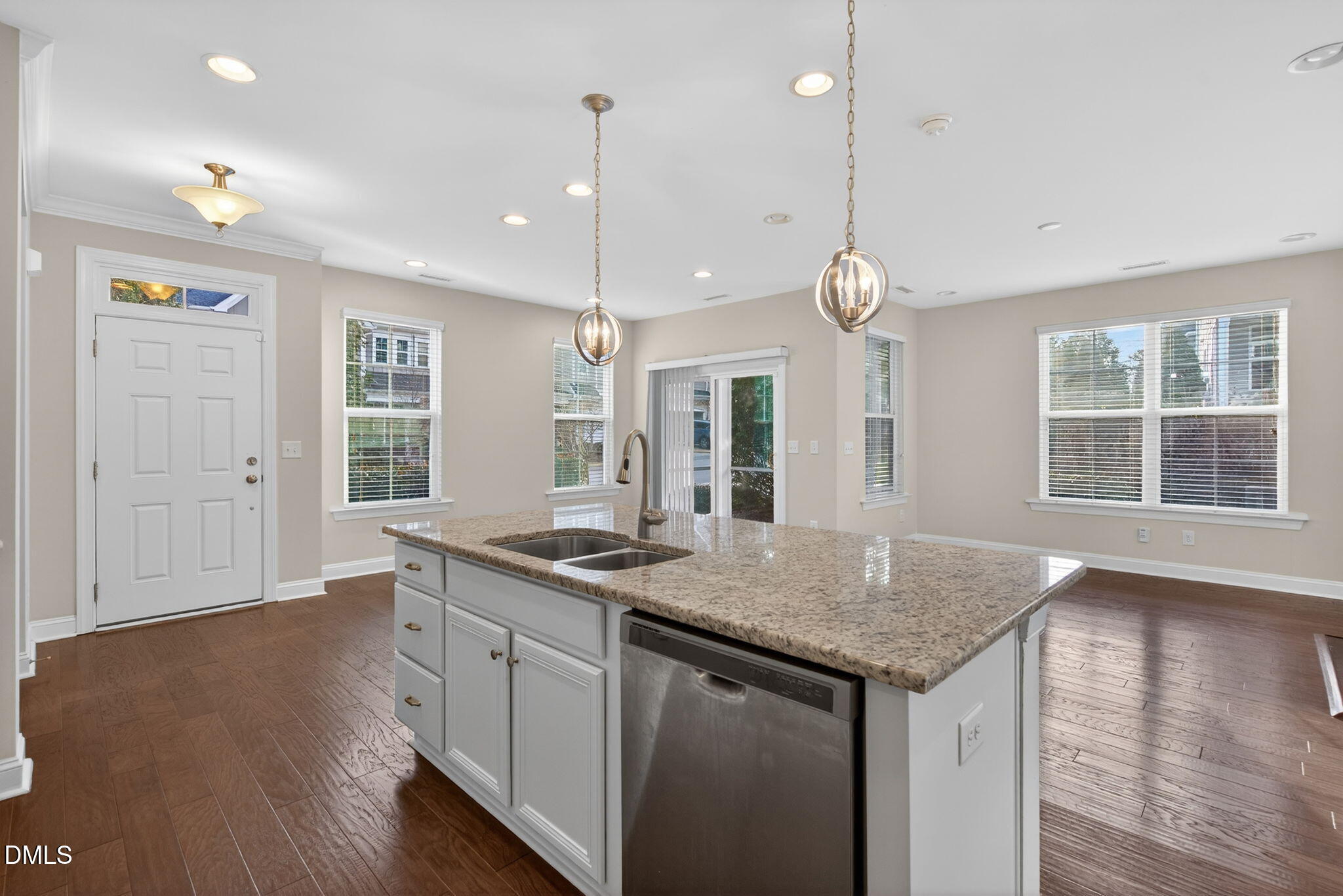 1103 Laurel Twist Road Cary, NC 27513 - Photo 8 of 38 a kitchen with a granite countertop sink and wooden floor