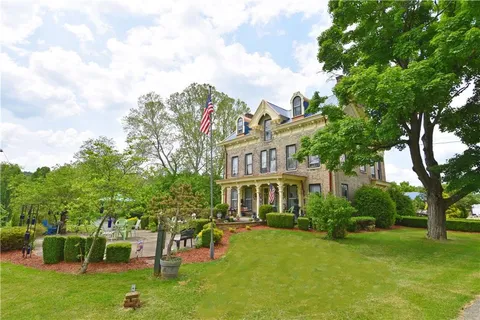 a view of a house with a backyard
