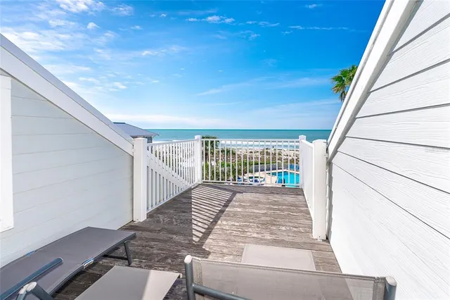 a view of a balcony with hardwood