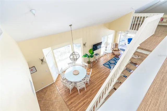 a bedroom with a bed and a large window with wooden floor