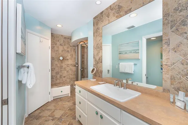 a bathroom with a glass shower door