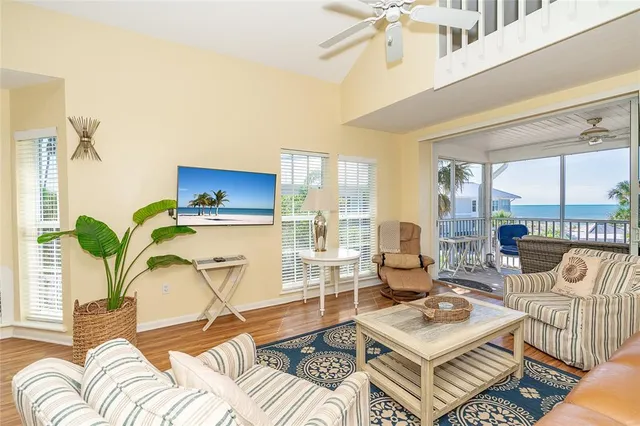 a living room with furniture and a floor to ceiling window