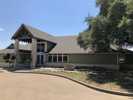 a front view of a house with yard and seating space