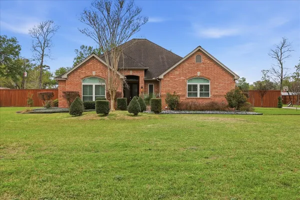 a front view of house with yard and green space