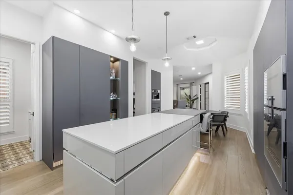 a large white room with a large window and chandelier