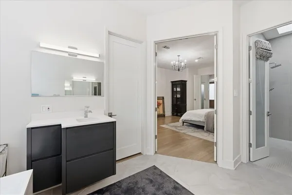 a en suite bathroom with a sink and mirror