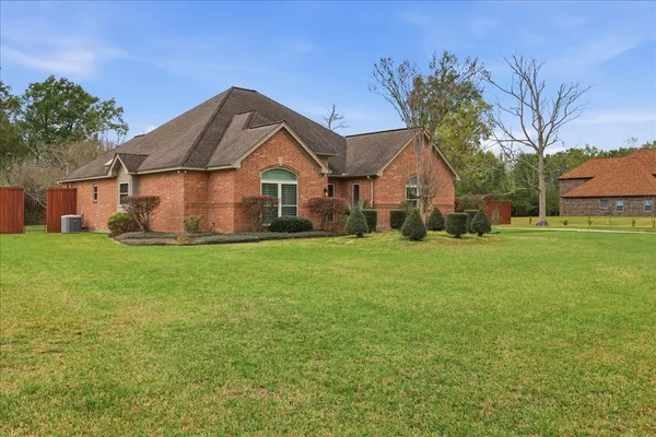 a front view of house with yard and green space