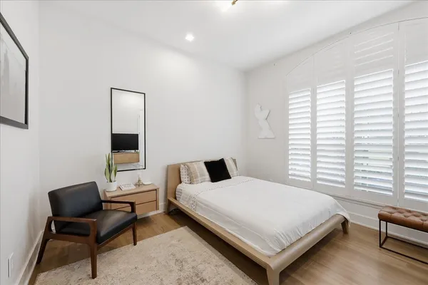 a bedroom with a bed and a chair