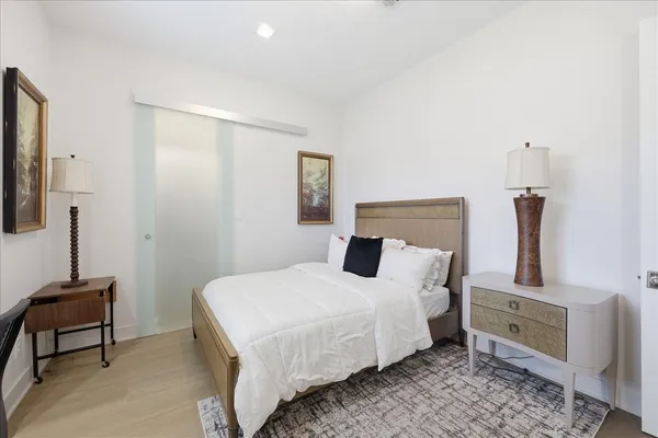 a bedroom with a bed and a chair