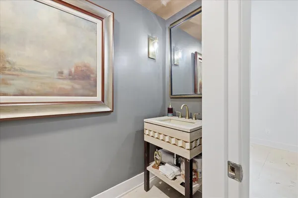a bathroom with a sink a toilet and mirror