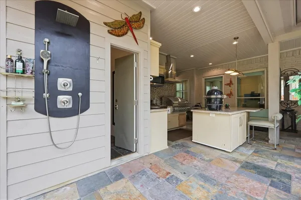 a view of kitchen with refrigerator and microwave