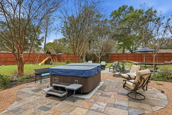 a view of a backyard with furniture and a slide