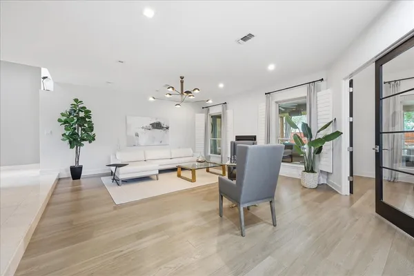 a living room with furniture and a potted plant