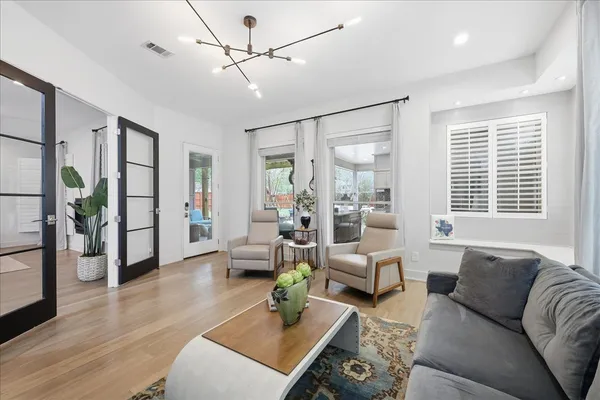 a living room with furniture and wooden floor