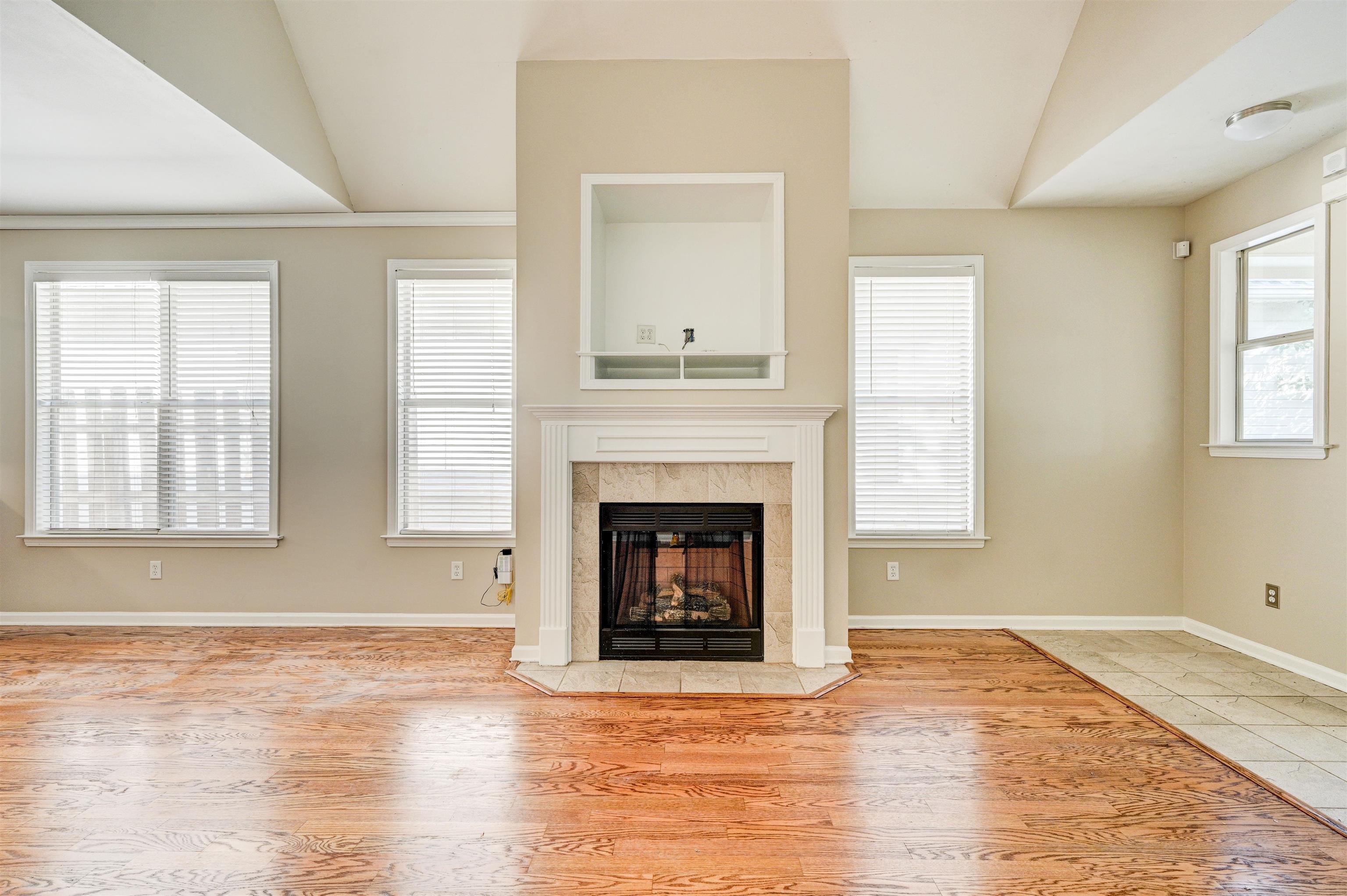 1355 Island Ridge Drive Memphis, TN 38103 - Photo 4 of 21 a view of an empty room with wooden floor and a window