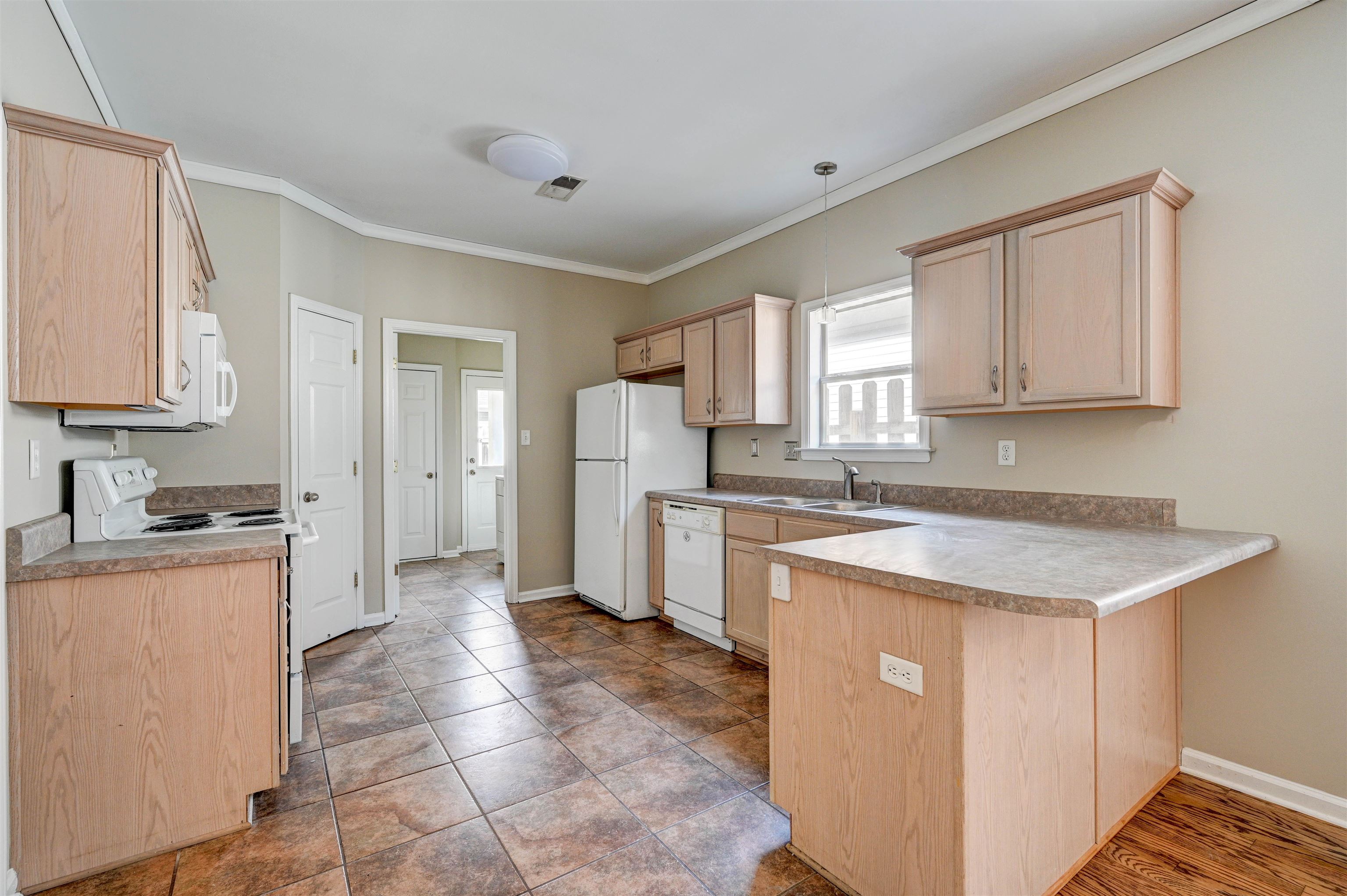 1355 Island Ridge Drive Memphis, TN 38103 - Photo 6 of 21 a kitchen with granite countertop a sink a counter top space and stainless steel appliances