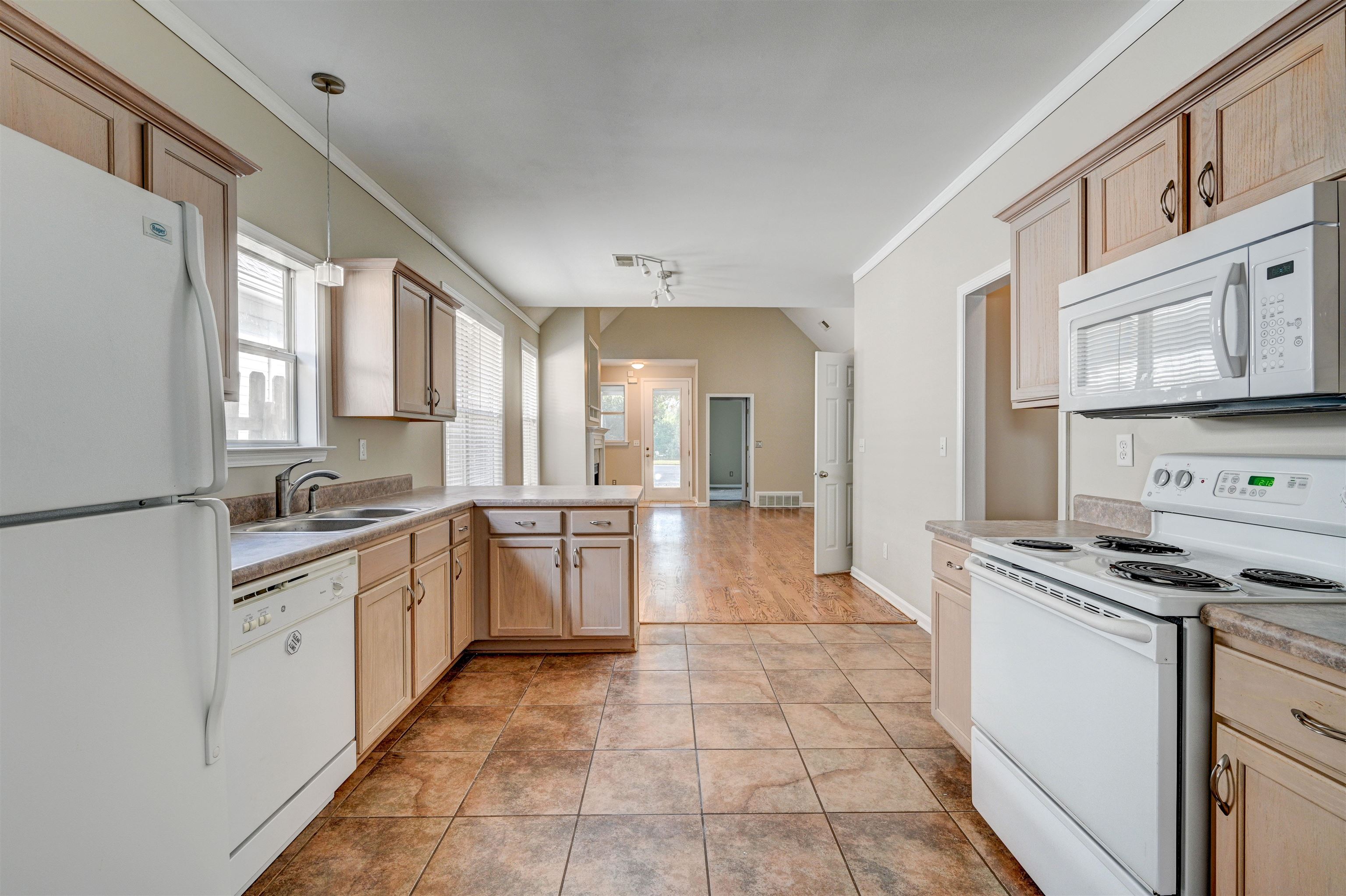 1355 Island Ridge Drive Memphis, TN 38103 - Photo 8 of 21 a kitchen with stainless steel appliances granite countertop a stove a sink and a refrigerator