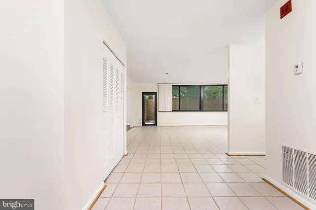 a bedroom with a bed a couch and potted plant