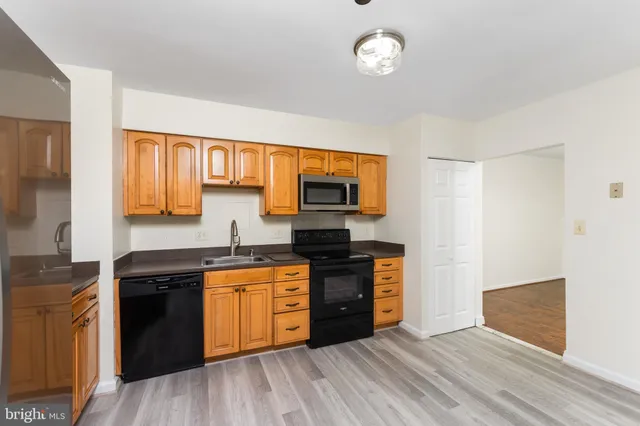 a view of a hallway with wooden shelves