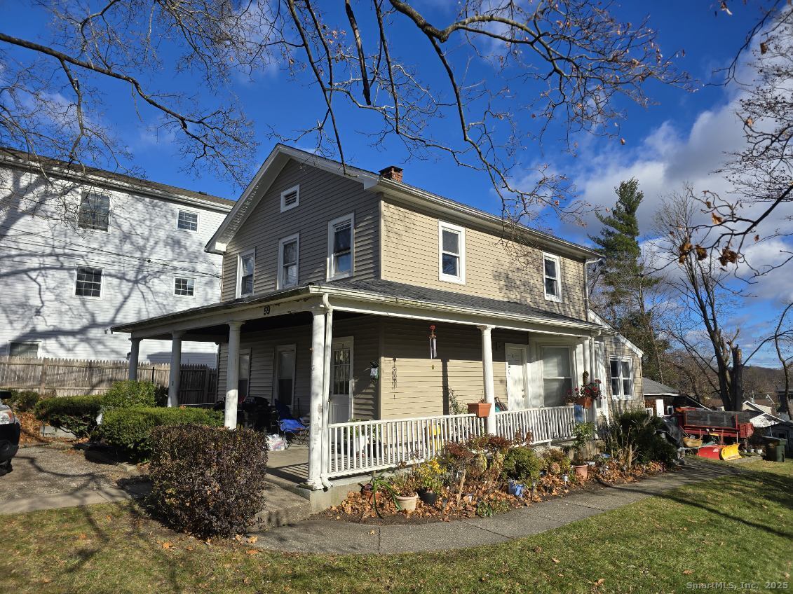 59 Pleasant Street Danbury, CT 06810 - Photo 1 of 4 a front view of a house with garden