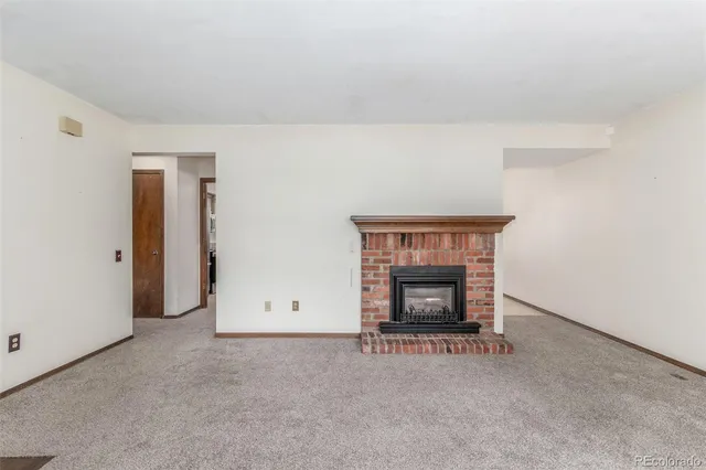 a view of an empty room with a fireplace