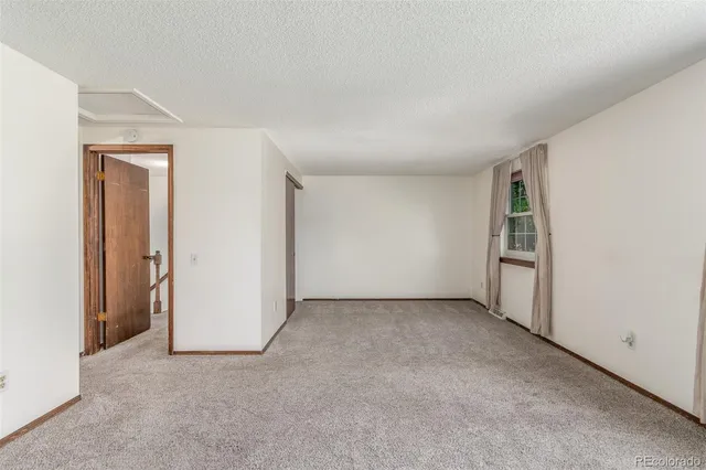 a view of an empty room and closet area