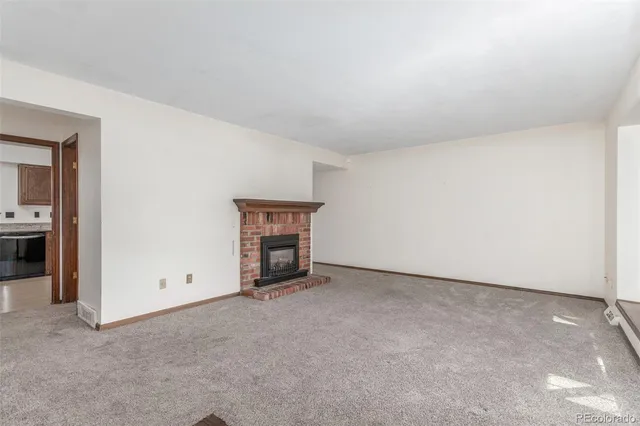 a view of an empty room with a fireplace