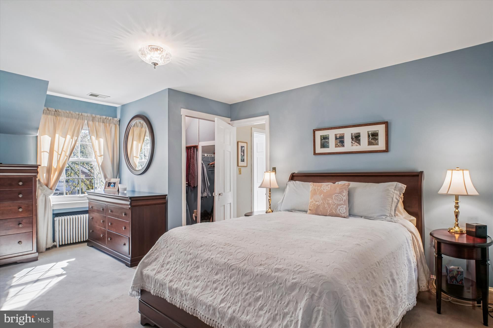 5103 Fairglen Lane Chevy Chase, MD 20815 - Photo 17 of 41 a bed room with a bed a mirror and a chandelier